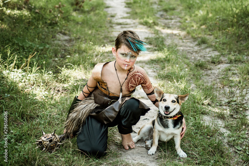 cosplay of Ukrainian Kozak. Cute Caucasian boy holding mace with emblem of Ukraine pretending to be fearless warrior.