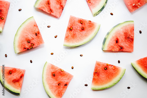 Sliced watermelon and seeds on white background  top view