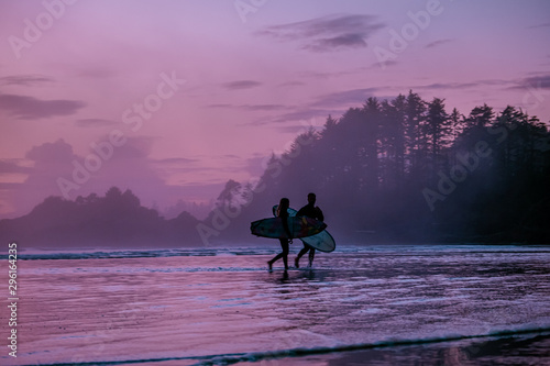 Tofino Vancouver Island, sunset at cox bay with surfers by the ocean during fall season Canada