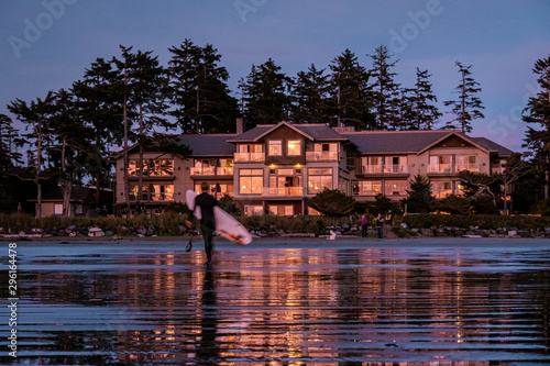 Tofino Vancouver Island, sunset at cox bay with surfers by the ocean during fall season Canada