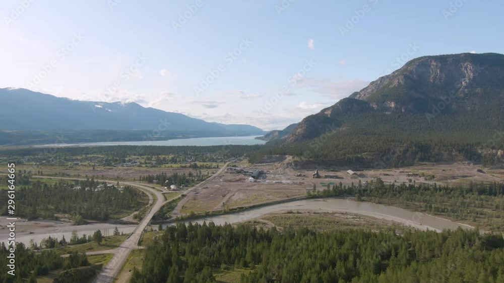 Aerial Panoramic View of Small Town, Canal Flats, during a sunny and cloudy summer day. Located in the Kootenay, British Columbia, Canada. Aerial Panoramic View of Small Town, Canal Flats, during a sunny and cloudy summer day. Located in the Kootenay, British Columbia, Canada.