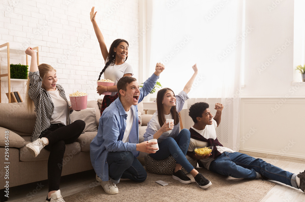 Fototapeta premium Young football fans. Friends cheering for favourite team