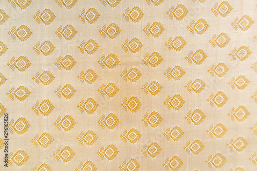 Maski, India - October ,6 2019 - Traditional Indian Silk Saree border pattern with golden bright colors and floral design.