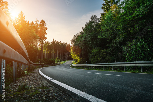 Fototapeta Naklejka Na Ścianę i Meble -  Long Curvy Forest Road In Alpine Mountains