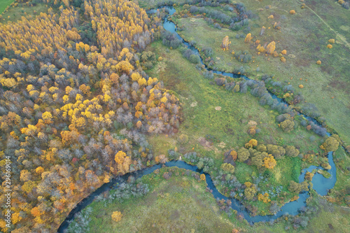 Aerial view with a drone. Winding river with autumn forest  top view
