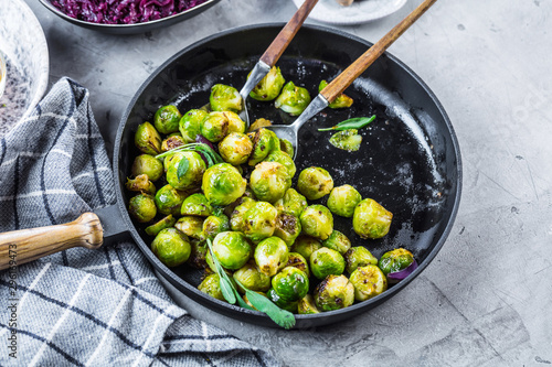 Frying pan with roasted brussel sprouts on table photo