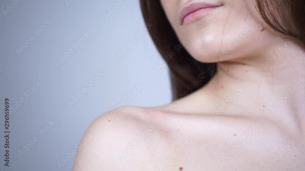 The girl takes off the bra strap. Bare shoulder. The girl takes off the bra strap. Bare shoulder.