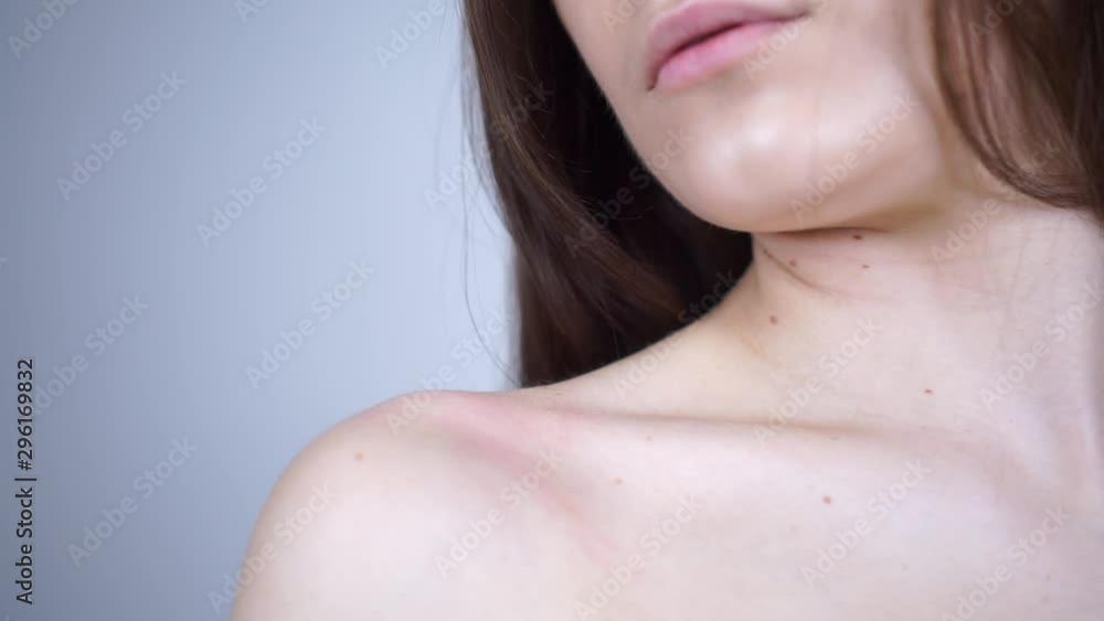 The girl takes off the bra strap. Bare shoulder. The girl takes off the bra strap. Bare shoulder.