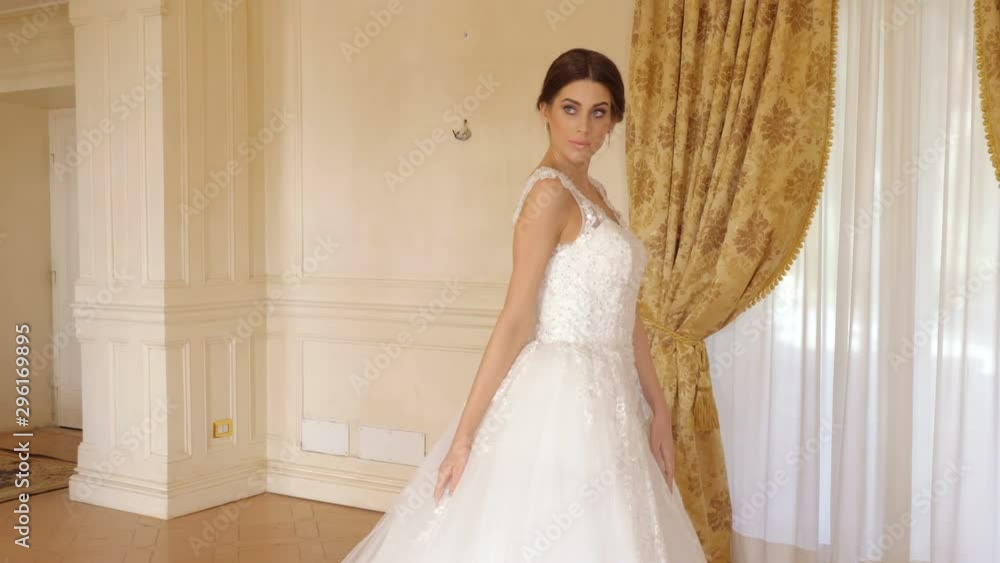 Elegant Beautiful young woman posing in bridal dress for photgrapher Elegant Beautiful young woman posing in bridal dress for photgrapher