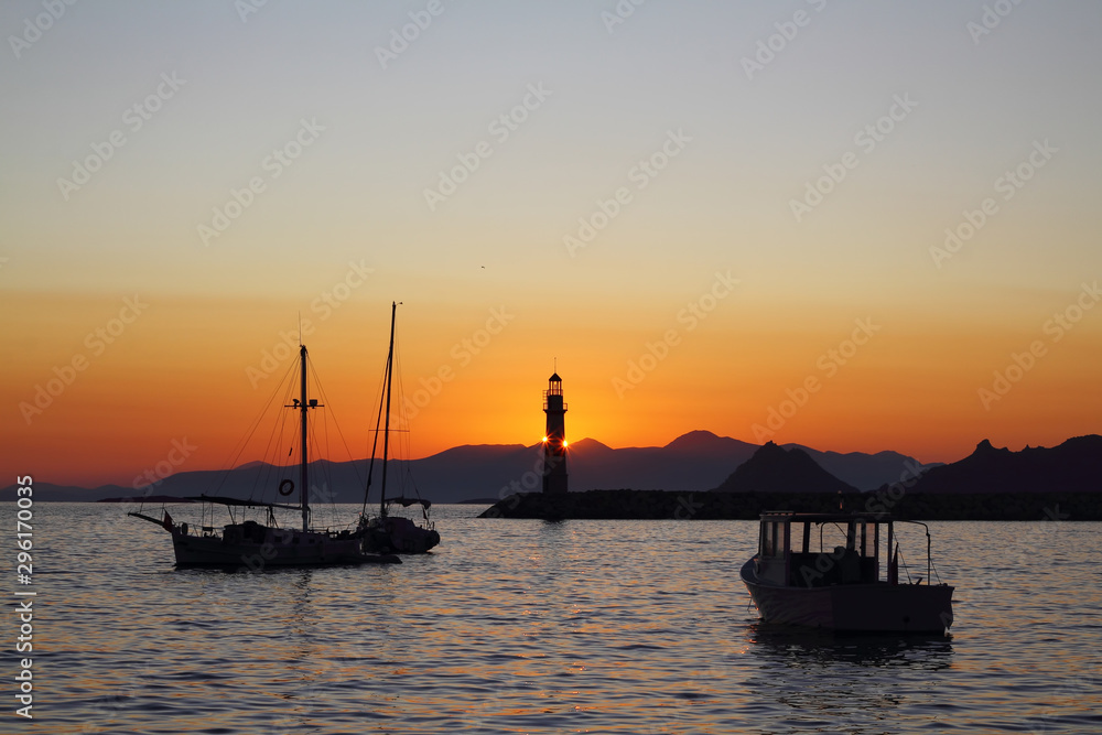 Seascape at sunset. Lighthouse on the coast. Seaside town of Turgutreis and spectacular sunsets Seascape at sunset. Lighthouse on the coast. Seaside town of Turgutreis and spectacular sunsets
