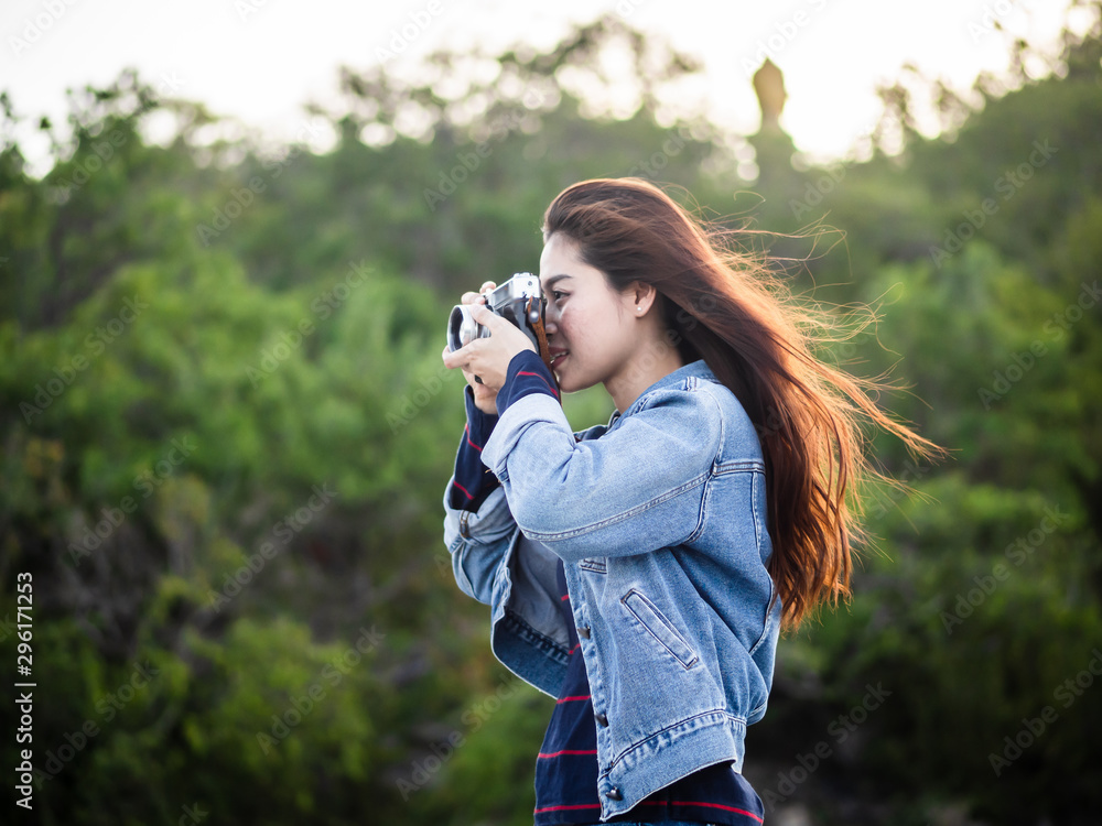 Happy Asian woman vintage camera with nature background, camping concept.