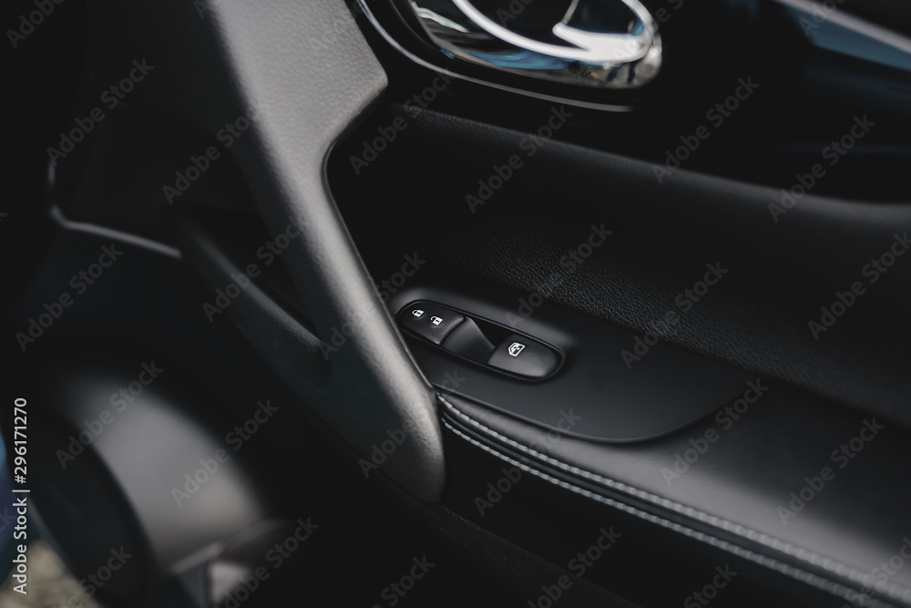Control panel in the car door. Car door handle with adjustment knobs.