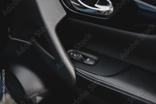Control panel in the car door. Car door handle with adjustment knobs. © kucheruk