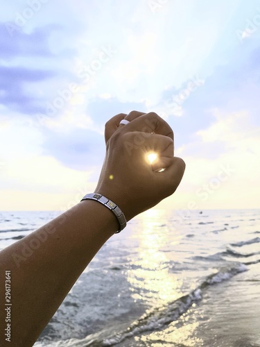 bottle in hand on the background of blue sky