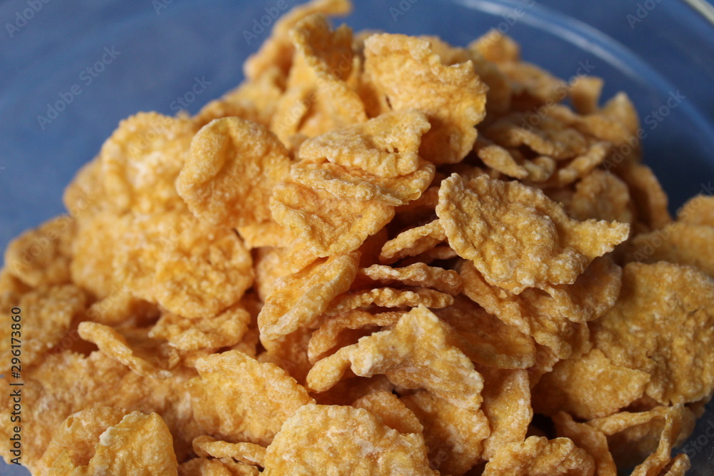 cornflakes in a plate on a blue background cornflakes in a plate on a blue background