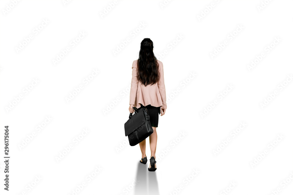 Back view of female worker walks on studio Back view of female worker walks on studio