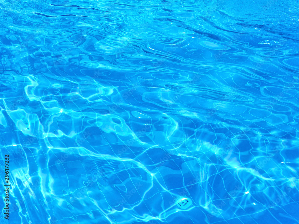 Ripples appeared on the surface of the water in the pool. The pattern on the bottom of the pool is distorted due to water