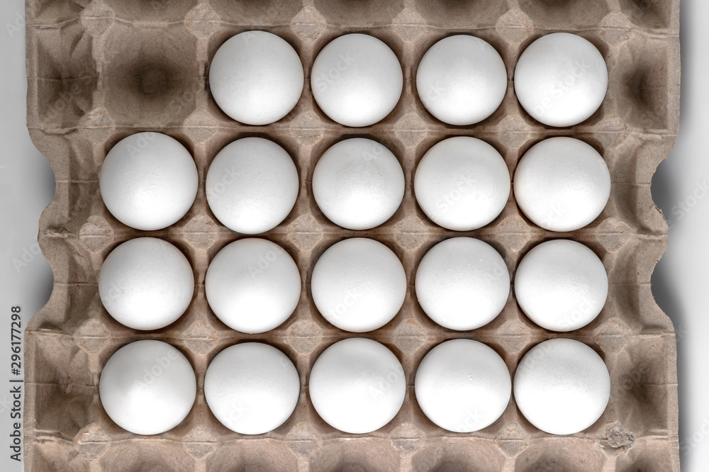 Top view on chicken raw eggs in carton recyclable cardboard box. Close-up view on natural pattern Top view on chicken raw eggs in carton recyclable cardboard box. Close-up view on natural pattern