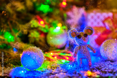 Knitted mouse is surrounded by Christmas decorations. Year of rat. symbol of 2020. © Eduard Vladimirovich