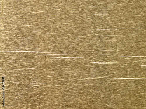 Brushed gold metal background or groove texture of polished steel plate with reflections Iron plate and shiny