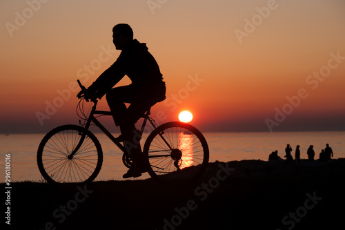 Silhouette of cyclist at sunset