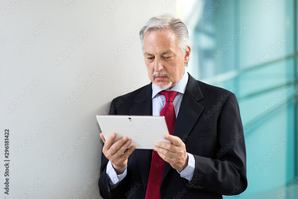 Senior manager using a digital tablet outdoor Senior manager using a digital tablet outdoor