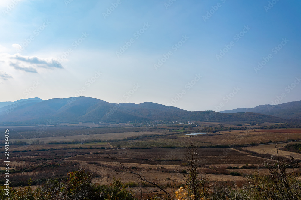 Change of seasons in the mountains. Autumn in warm yellow and brown colors.