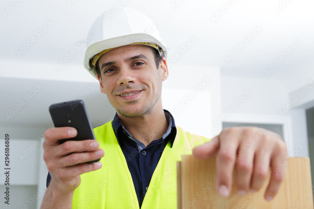 carpenter is using mobile phone on site carpenter is using mobile phone on site