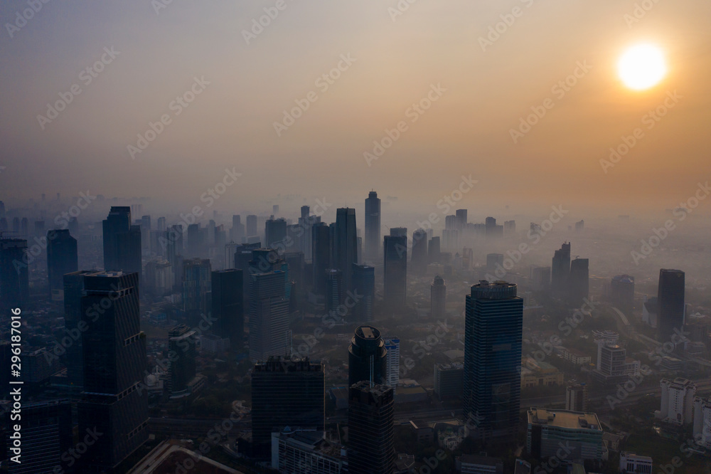 Skyscrapers covered by air pollution at sunset