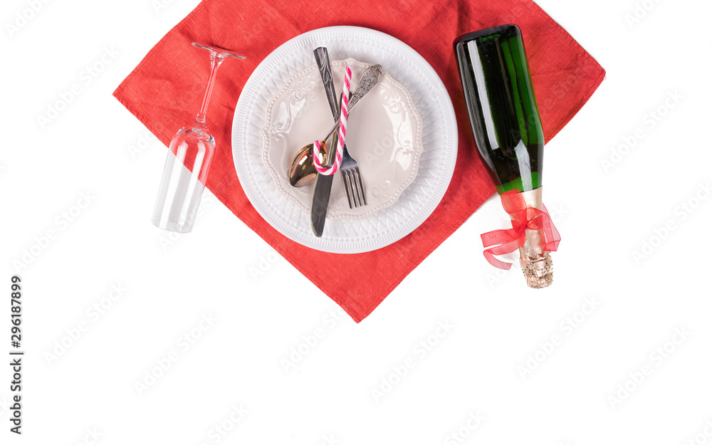 Christmas table setting. Red decoration and candles with Santa hat Christmas table setting. Red decoration and candles with Santa hat