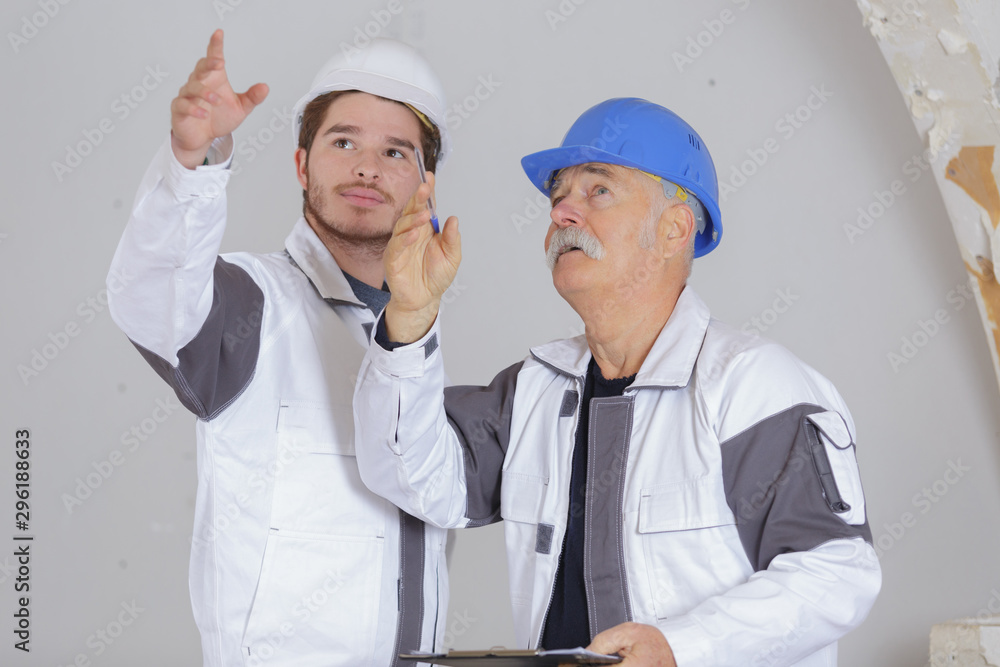 modern building and workers pointing at problem modern building and workers pointing at problem