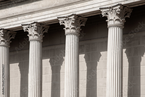 Vintage Old Justice Courthouse Column. Neoclassical colonnade with corinthian columns as part of a public building resembling a Greek or Roman temple