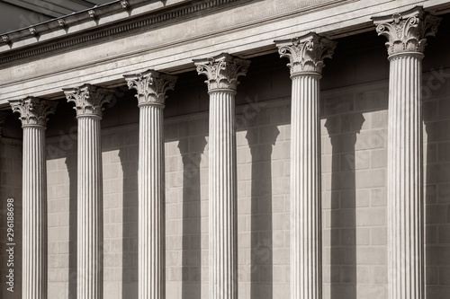 Vintage Old Justice Courthouse Column. Neoclassical colonnade with corinthian columns as part of a public building resembling a Greek or Roman temple