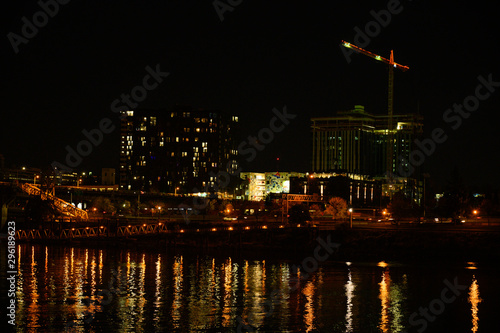 City at night, landscape. Beautiful night city with lights and reflection in the river.