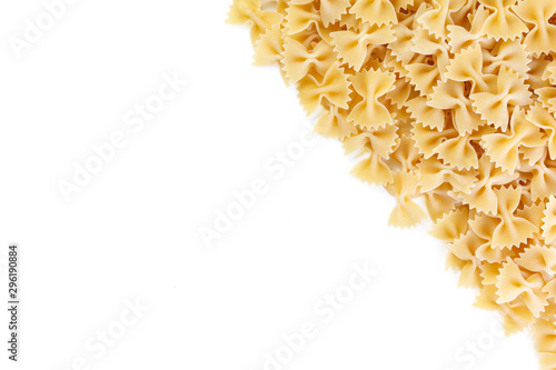 Variety of types and shapes of Italian pasta. Dry pasta background. A portion of Farfalle bows pasta isolated on white . Heap of bow tie pasta isolated on white background.