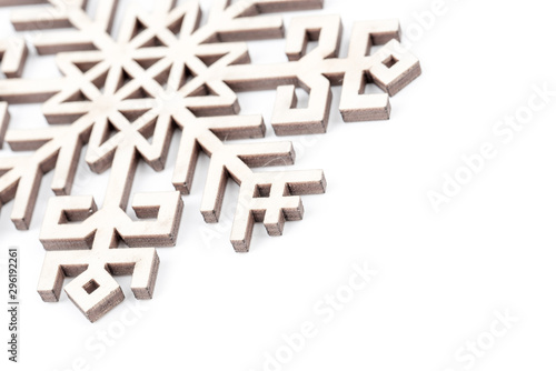 Winter, Christmas, New Year greeting card. Wooden decoration - white snowflake, star. Decor made from natural wood. Isolated on white background. Closeup. Place for text, copy space. Top view