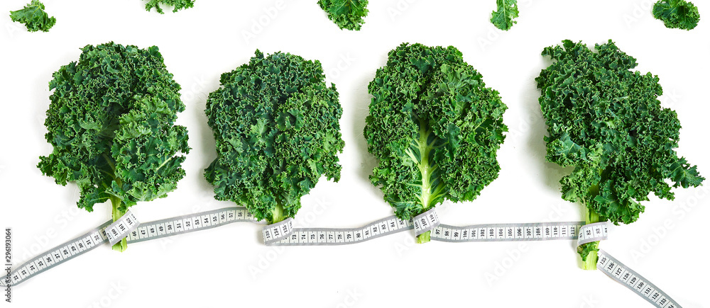 creative layout kale with measuring tape concept diet, healthy lifestyle, diet, vegetarian, top view, flat lay creative layout kale with measuring tape concept diet, healthy lifestyle, diet, vegetarian, top view, flat lay