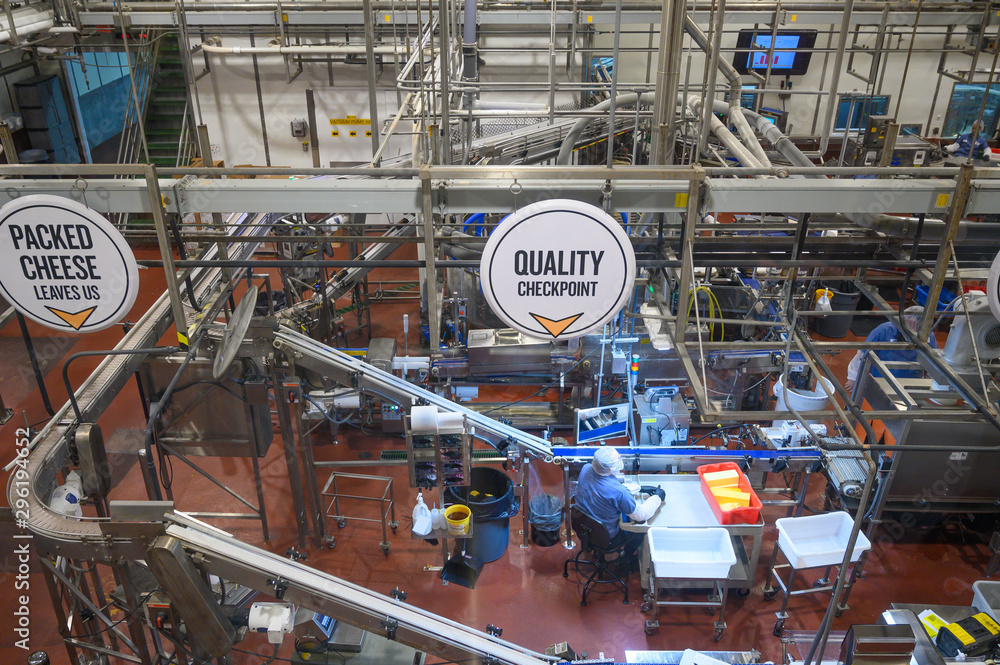 Dairy plant, factory in operating mode. Production of cheese, milk, yogurt and sour cream. Operating mode with automation and quality control.