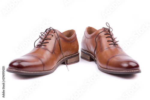Brown leather male shoes, white background. Men's ankle boot leather isolated on white background, closed up. For business and office. Official and casual, footwear. Front view. Closeup. Isolated.