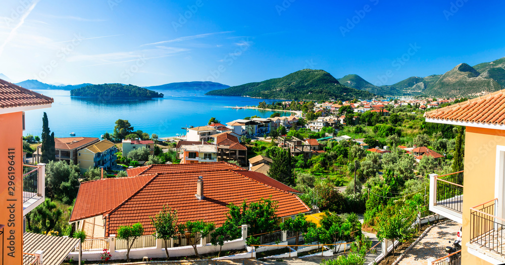 Fototapeta premium Greece Lefkada Island View of Nidri Bay with Red Tiled Roofs of Luxury Villas and Holiday Homes Overlooking Turquoise Sea Traditional Ionian Architecture Summer Travel 8K