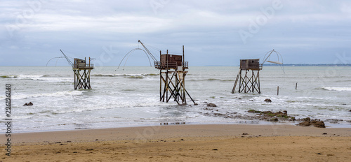 Panoramic view of three typical carrelet fishing huts on a beach in Saint-Michel-Chef-Chef, Loire-Atlantique department, western France. photo