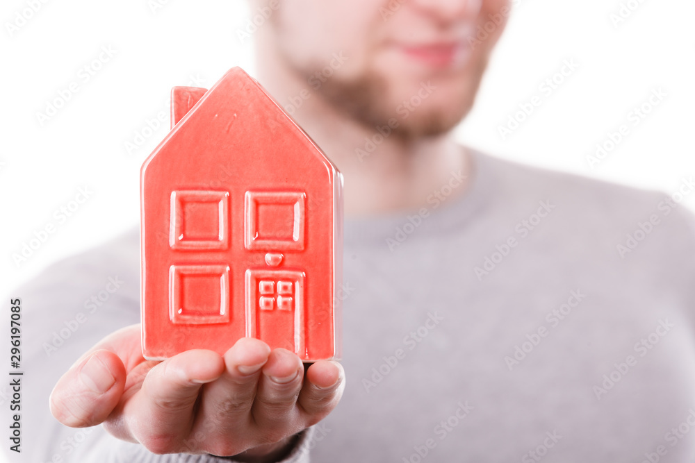Young man holding house on palm. Young man holding house on palm.