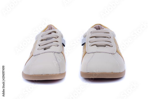 Classic leather elegant shoes on a white background. Beautiful cream, gray, brown kids casual leather shoes. One to the other. Top, side view. Both legs. Isolated.