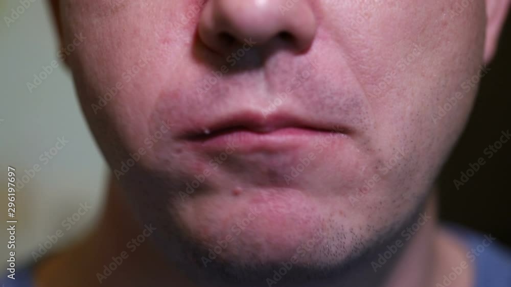 man eats a donut in white glaze. close-up man eats a donut in white glaze. close-up