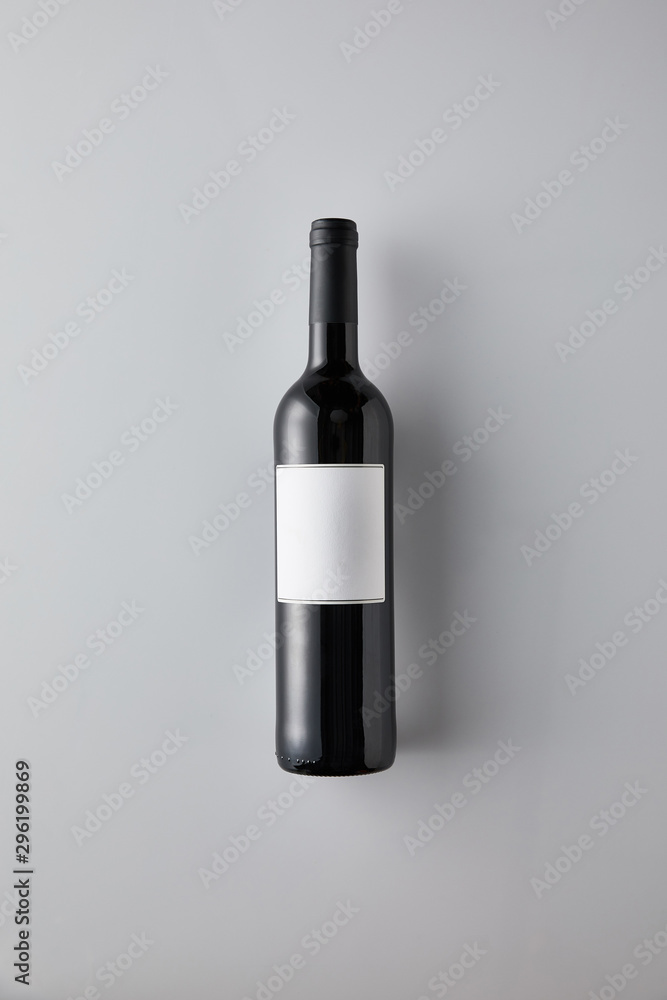 top view of bottle with red wine and blank label on white background top view of bottle with red wine and blank label on white background