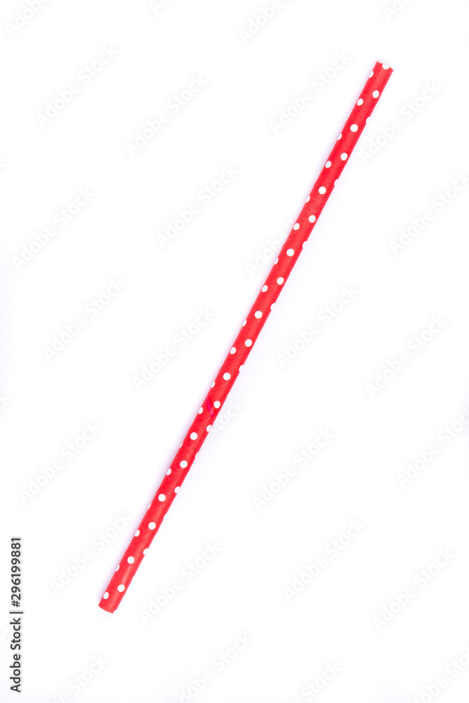 Closeup of drinking straw for party.  Red with white dots. Top view of colorful disposable eco-friendly straw for summer cocktails. Paper coctail colorful straw isolated on white  background, isolated
