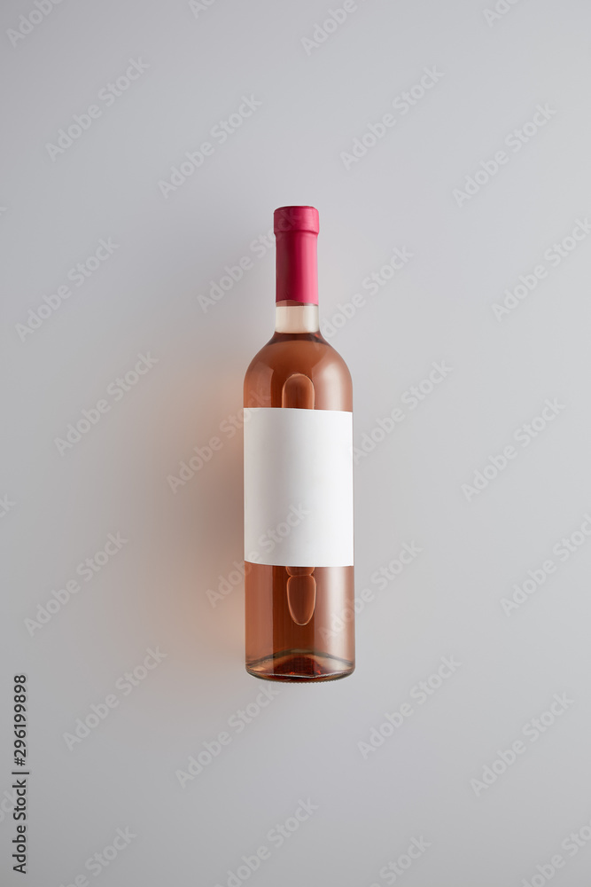 top view of bottle with rose wine and blank label on white background top view of bottle with rose wine and blank label on white background