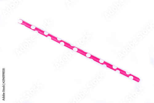 Closeup of drinking straw for party.  Pink with white dots. Top view of colorful disposable eco-friendly straw for summer cocktails. Paper coctail colorful straw isolated on white  background, isolate
