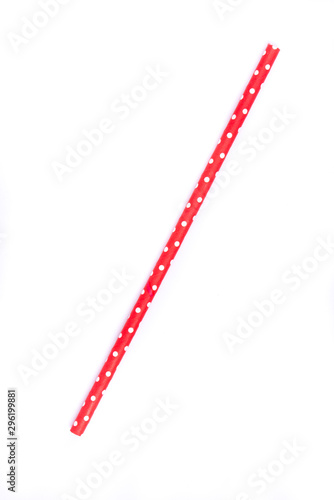 Closeup of drinking straw for party.  Red with white dots. Top view of colorful disposable eco-friendly straw for summer cocktails. Paper coctail colorful straw isolated on white  background, isolated
