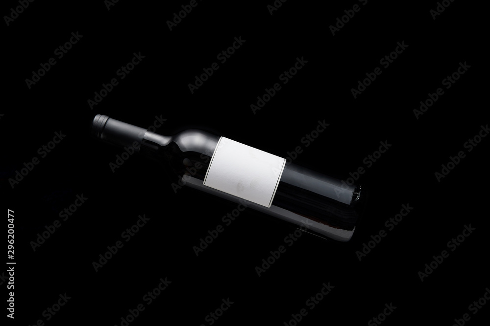 top view of bottle with wine and blank white label isolated on black top view of bottle with wine and blank white label isolated on black